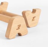 Detailaufnahme der Bmotion Parallettes aus Holz mit graviertem Logo auf weißem Hintergrund.
